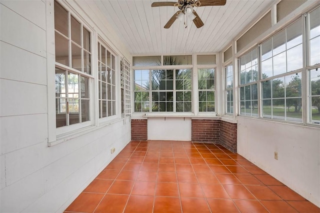 unfurnished sunroom with tile patterned floors and wooden ceiling