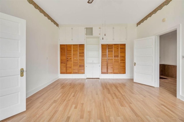 empty room featuring light wood finished floors and baseboards