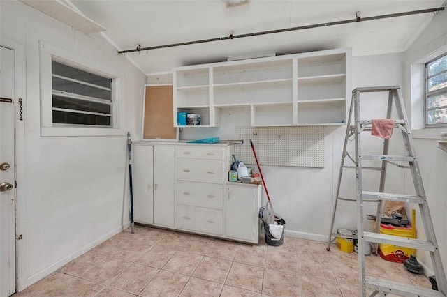 bedroom featuring baseboards and light tile patterned floors