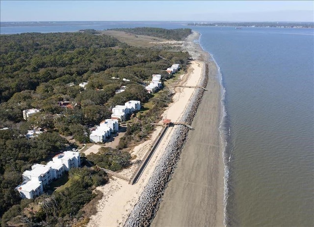 birds eye view of property with a water view and a view of the beach