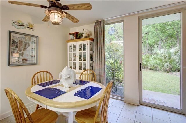 tiled dining space with ceiling fan