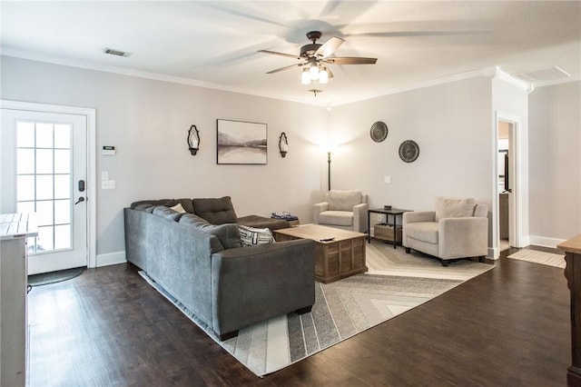 living room with dark hardwood / wood-style flooring, crown molding, and ceiling fan