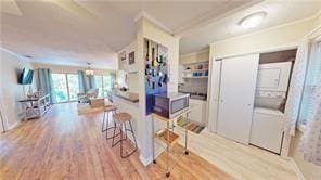 800 Mallery St Unit 3, Saint Simons Island, GA 31522 - kitchen with crown molding, wood finished floors, and stainless steel microwave