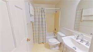 800 Mallery St Unit 3, Saint Simons Island, GA 31522 - bathroom with shower / tub combo with curtain, toilet, and a sink