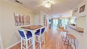 800 Mallery St Unit 3, Saint Simons Island, GA 31522 - dining room featuring wood finished floors, ceiling fan, ornamental molding, and baseboards