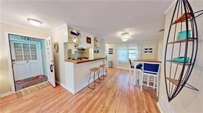 800 Mallery St Unit 3, Saint Simons Island, GA 31522 - kitchen featuring wood finished floors, baseboards, healthy amount of natural light, and ornamental molding