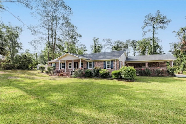 single story home featuring covered porch, a front yard, and brick siding
