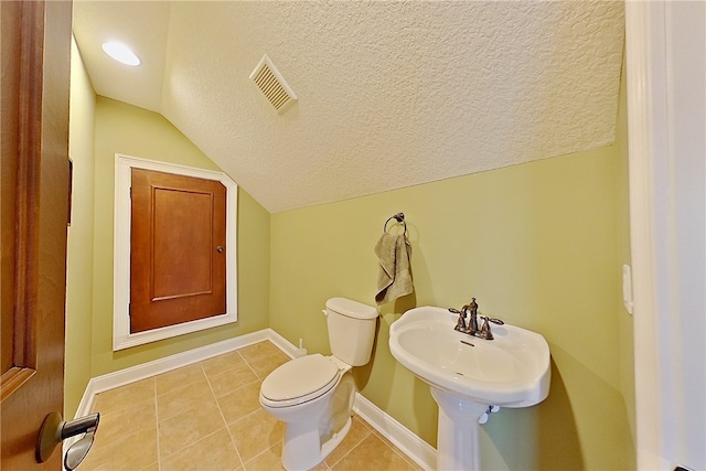 4949 Trudie Rd, Blackshear, GA 31516 - bathroom featuring vaulted ceiling, tile patterned flooring, and a textured ceiling