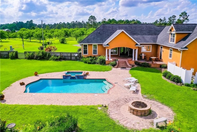 4949 Trudie Rd, Blackshear, GA 31516 - rear view of property with an outdoor fire pit, a fenced backyard, a patio, a pool with connected hot tub, and stucco siding