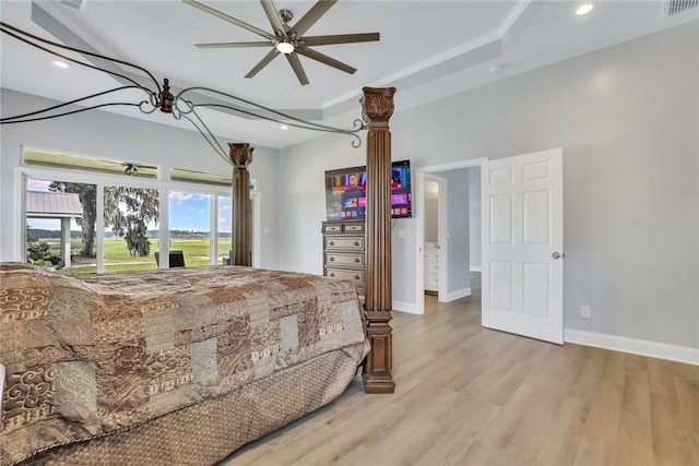 bedroom with ceiling fan, crown molding, and light hardwood / wood-style flooring