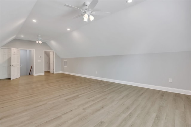 additional living space featuring ceiling fan, lofted ceiling, and light wood-type flooring