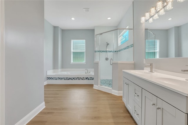 bathroom with separate shower and tub, vanity, and wood-type flooring