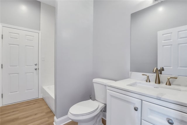 full bathroom with bathtub / shower combination, hardwood / wood-style floors, vanity, and toilet