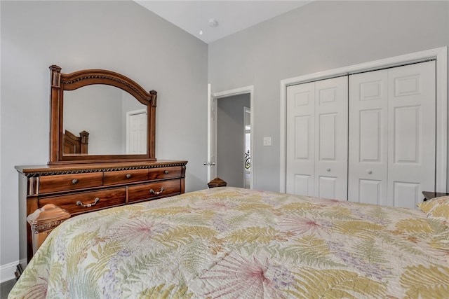 bedroom with lofted ceiling and a closet