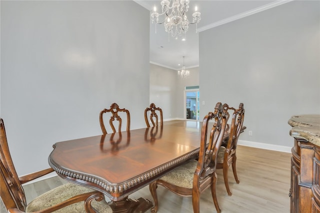 dining room featuring light hardwood / wood-style flooring, an inviting chandelier, and ornamental molding