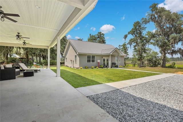 view of front of house featuring a patio area, ceiling fan, a front yard, and an outdoor living space