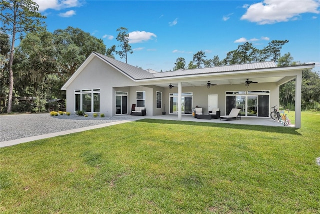 back of property featuring a lawn, ceiling fan, a patio area, and outdoor lounge area