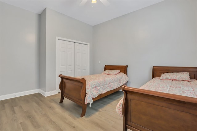 bedroom featuring ceiling fan, wood-type flooring, and a closet