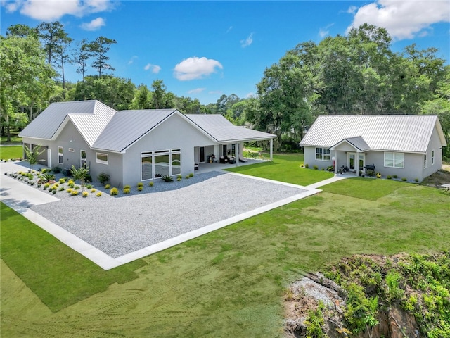 rear view of property featuring a lawn