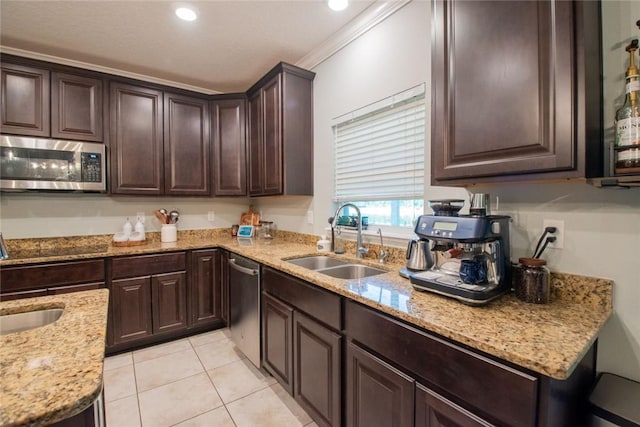 200 Pistachio Ln, Kingsland, GA 31548 - kitchen featuring appliances with stainless steel finishes, dark brown cabinets, light stone counters, light tile patterned floors, and recessed lighting