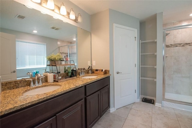 200 Pistachio Ln, Kingsland, GA 31548 - full bathroom featuring a stall shower, double vanity, tile patterned floors, and a closet