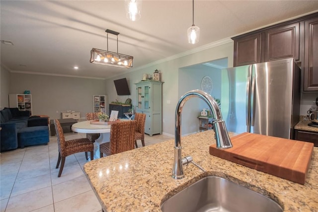 200 Pistachio Ln, Kingsland, GA 31548 - kitchen with freestanding refrigerator, open floor plan, crown molding, light tile patterned floors, and hanging light fixtures