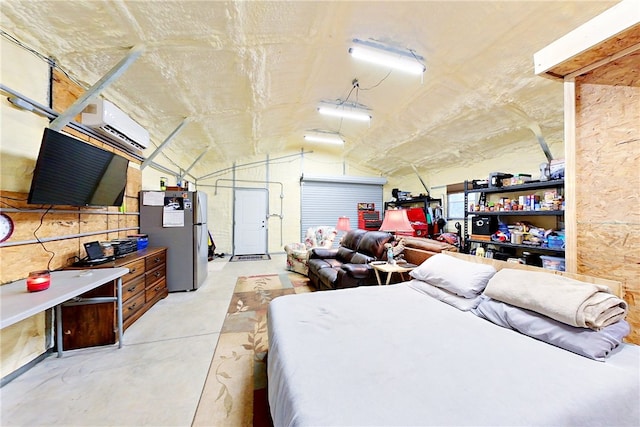 garage featuring stainless steel fridge and a wall unit AC