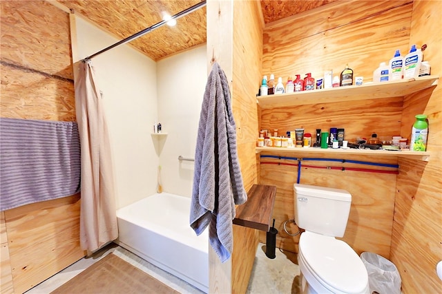 bathroom with shower / tub combo with curtain and toilet