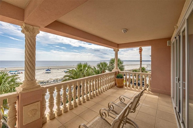 balcony with a view of the beach and a water view