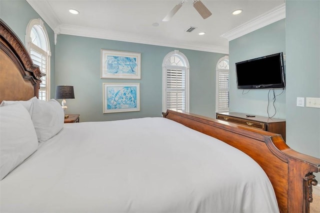 bedroom with ceiling fan, ornamental molding, and multiple windows