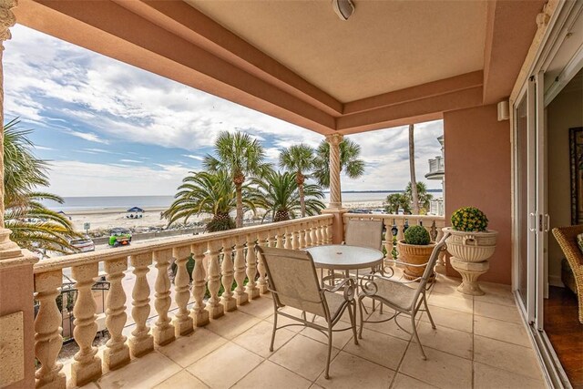 balcony with a water view and a beach view