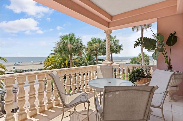 balcony with a water view and a beach view