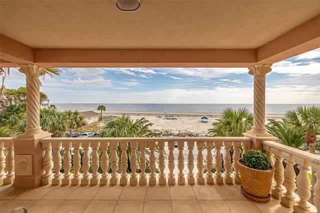 balcony with a water view and a beach view