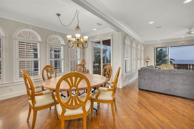 dining space featuring crown molding, ceiling fan with notable chandelier, and light hardwood / wood-style floors