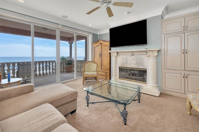 living room with crown molding, light colored carpet, ceiling fan, and a high end fireplace