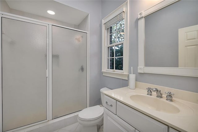 bathroom with vanity, toilet, and walk in shower