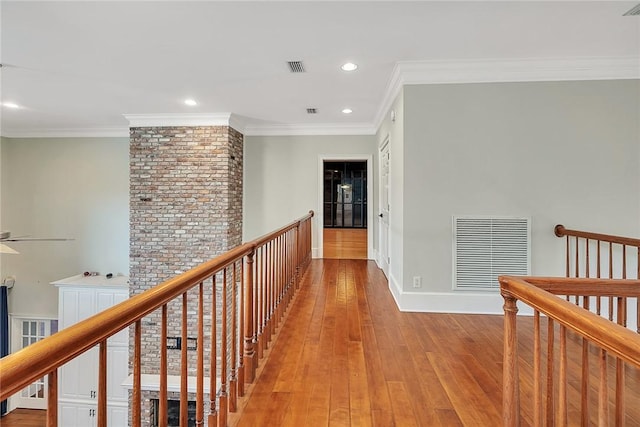 hall with crown molding and light hardwood / wood-style flooring