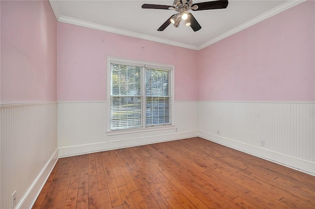 unfurnished room with hardwood / wood-style flooring, ornamental molding, and ceiling fan