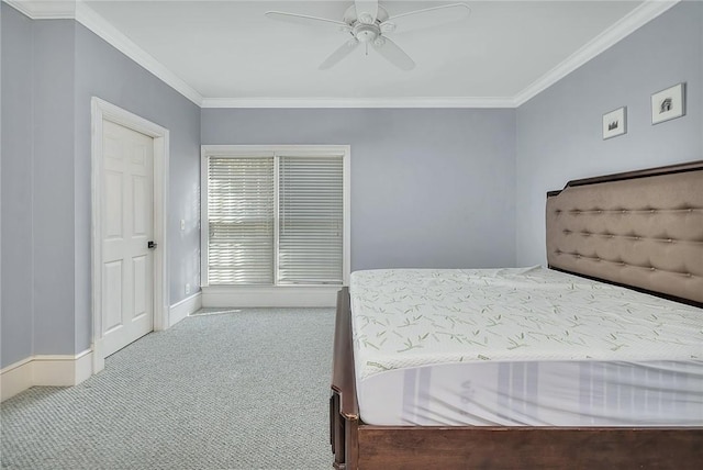 carpeted bedroom featuring ceiling fan and ornamental molding