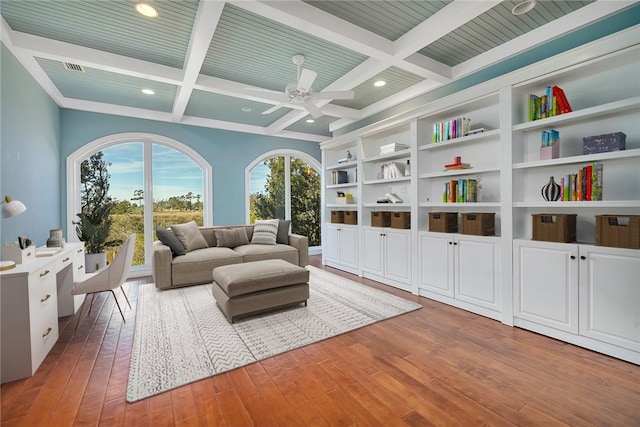 living area featuring coffered ceiling, hardwood / wood-style floors, and beam ceiling