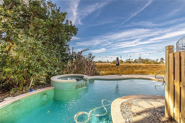 view of swimming pool featuring an in ground hot tub