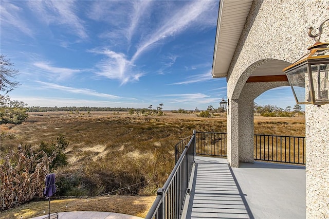 exterior space with a rural view and a balcony