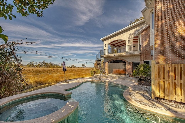 view of swimming pool with an in ground hot tub and a patio area