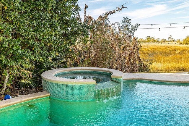 view of pool featuring an in ground hot tub