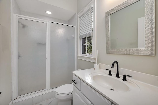 bathroom with vanity, toilet, and an enclosed shower