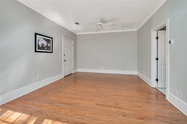 empty room with ceiling fan, ornamental molding, and light hardwood / wood-style floors