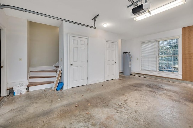 garage featuring a garage door opener and electric water heater