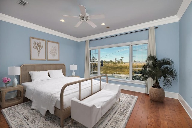 bedroom featuring hardwood / wood-style flooring, ornamental molding, and ceiling fan