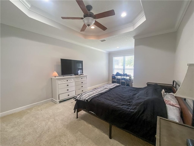 carpeted bedroom with ceiling fan, recessed lighting, baseboards, a tray ceiling, and ornamental molding