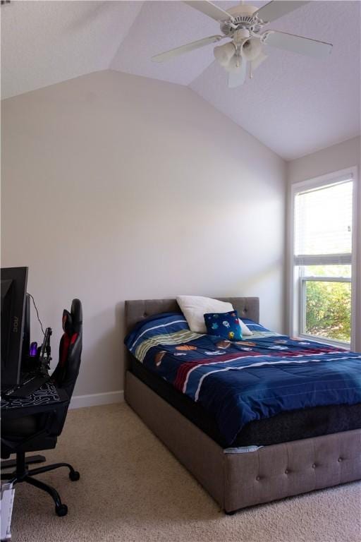 bedroom featuring baseboards, carpet, ceiling fan, and vaulted ceiling